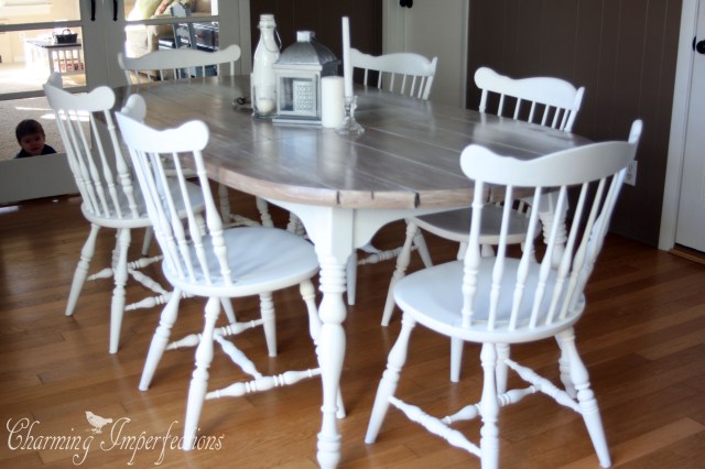 This dining room has it all, a big farmhouse table, a cozy chair to cuddle up by the blazing fire, and tons of windows that let lots of natural light into the room.